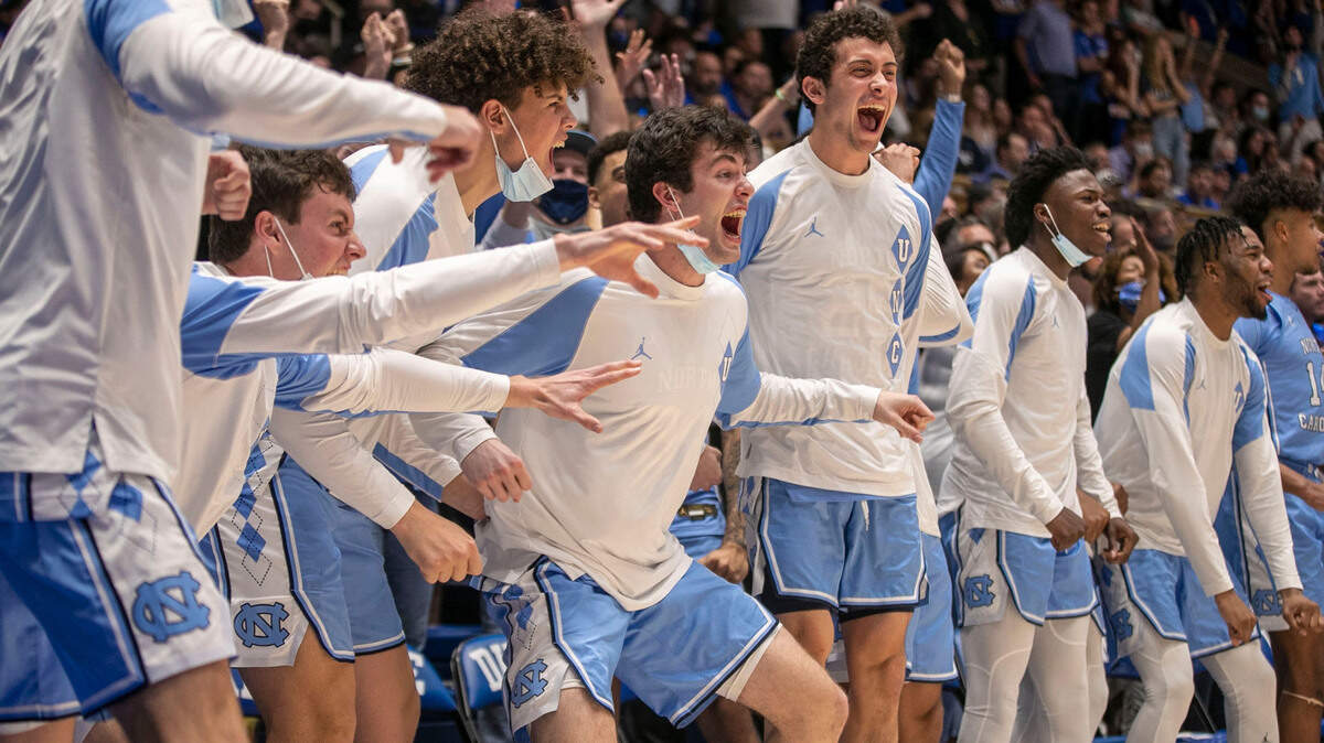 The North Carolina bench erupts in celebration, after an Armando Bacot dunk to give the Tar Heels a commanding 86-76 lead over Duke with :56 seconds to play on Saturday, March 5, 2022 in Durham, N.C. Bacot lead the Tar Heels with 23 points.