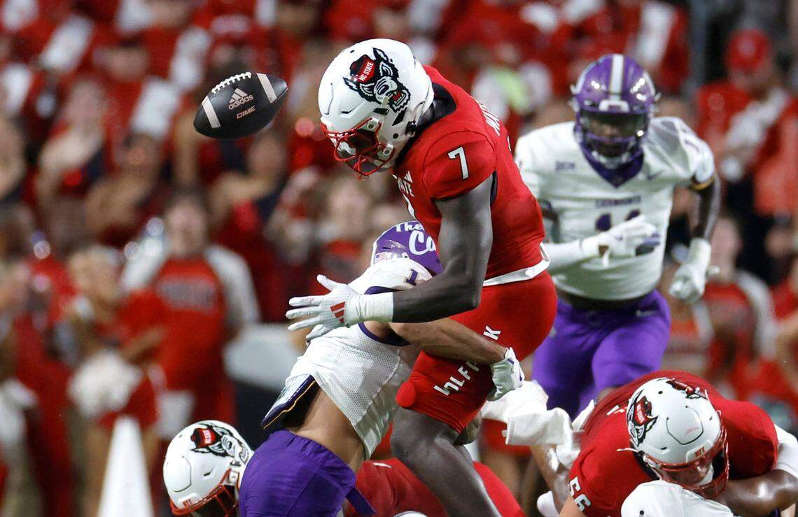 N.C. State running back Jordan Waters (7) loses the ball after being hit by Western Carolina safety Mateo Sudipo (1) during the first half of N.C. State’s game against Western Carolina at Carter-Finley Stadium in Raleigh, N.C., Thursday, August 29, 2024.