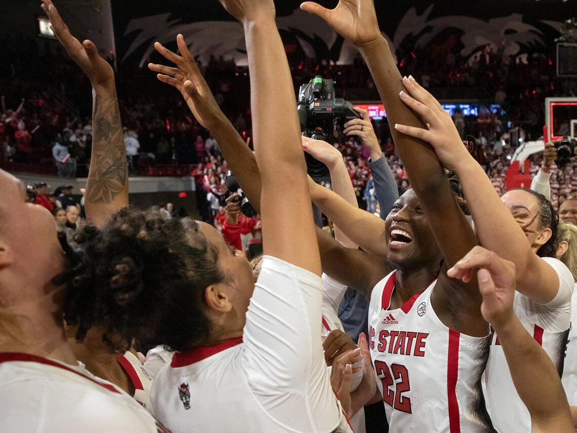 N.C. State’s Saniya Rivers celebrates with teammates after the Wolfpack defeated UConn 92-81 on Sunday, Nov. 12, 2023, at Reynolds Coliseum in Raleigh, N.C.