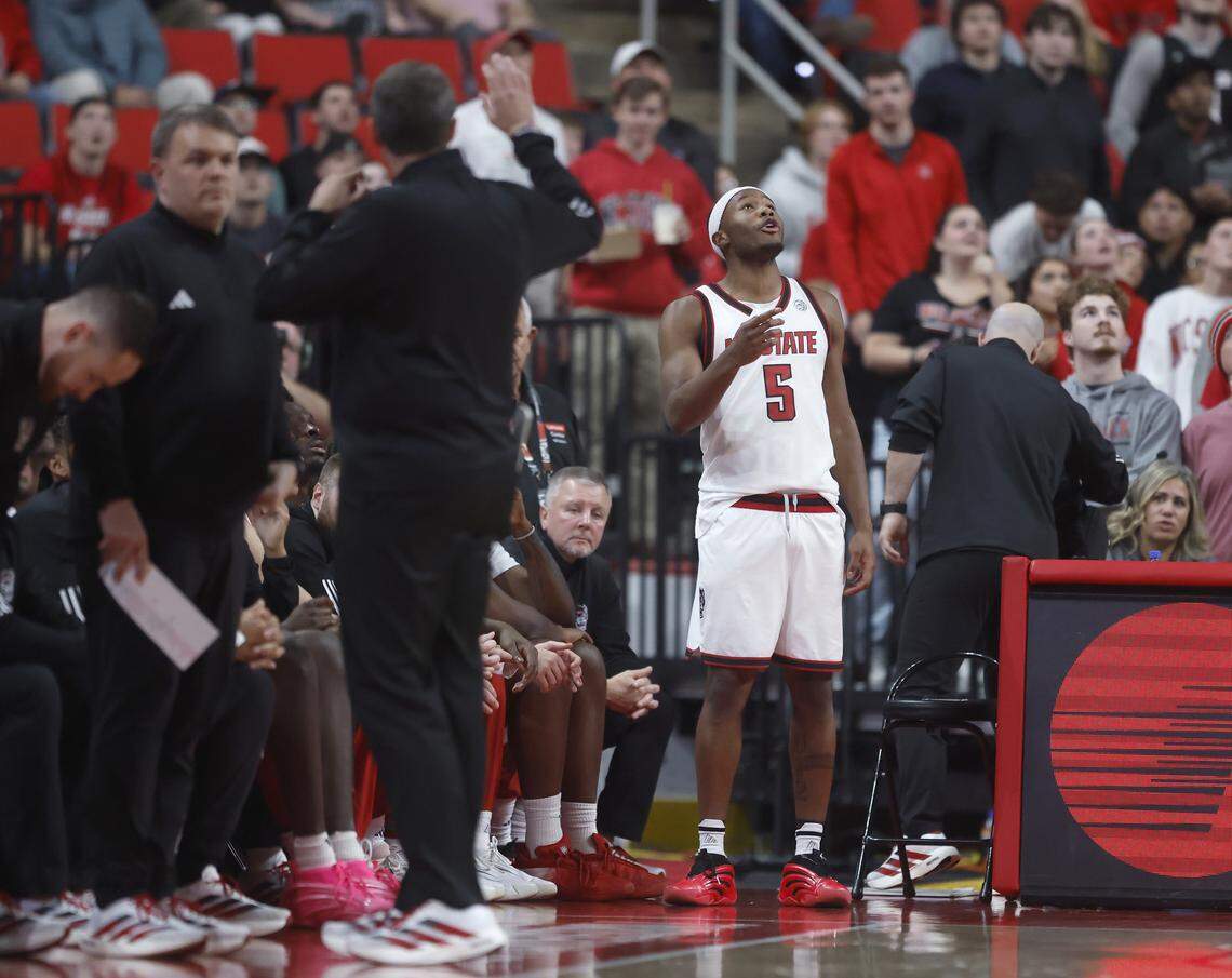 N.C. State’s Tre Holloman watches the replay after being ejected during the first half of the Wolfpack’s game against UNC Greensboro on Wednesday, Nov. 12, 2025, at Lenovo Center in Raleigh, N.C.