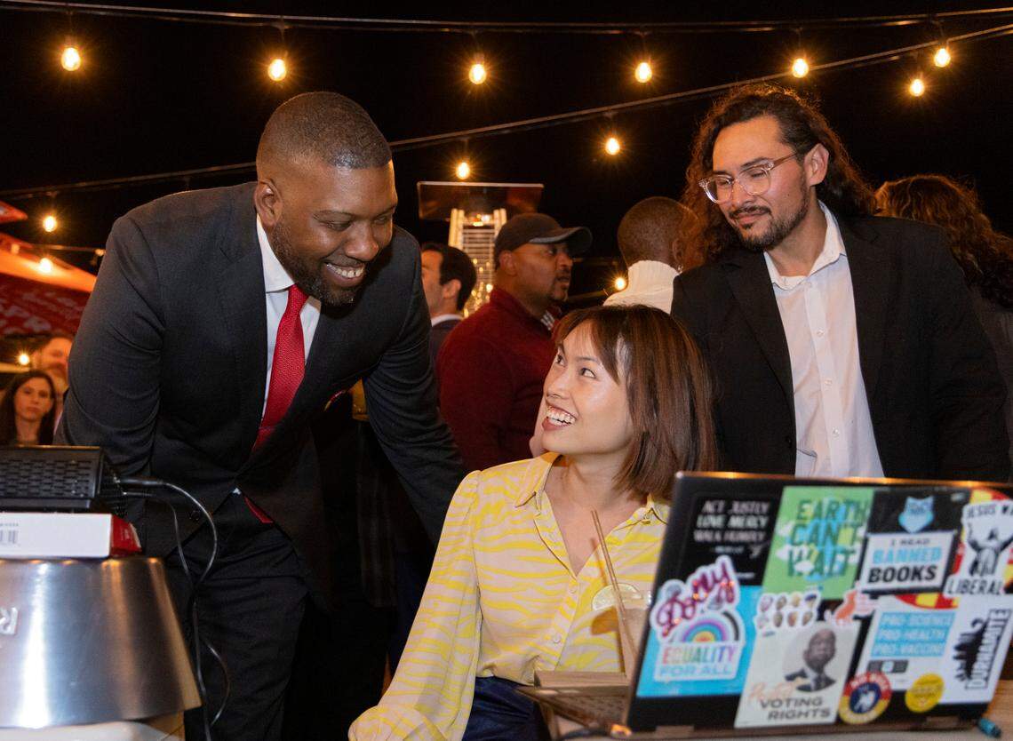 Durham mayoral candidate Leonardo Williams smiles as he watches election results update with his campaign manager, Chi Vo, center, at The Velvet Hippo on Tuesday, Nov. 7, 2023, in Durham, N.C.