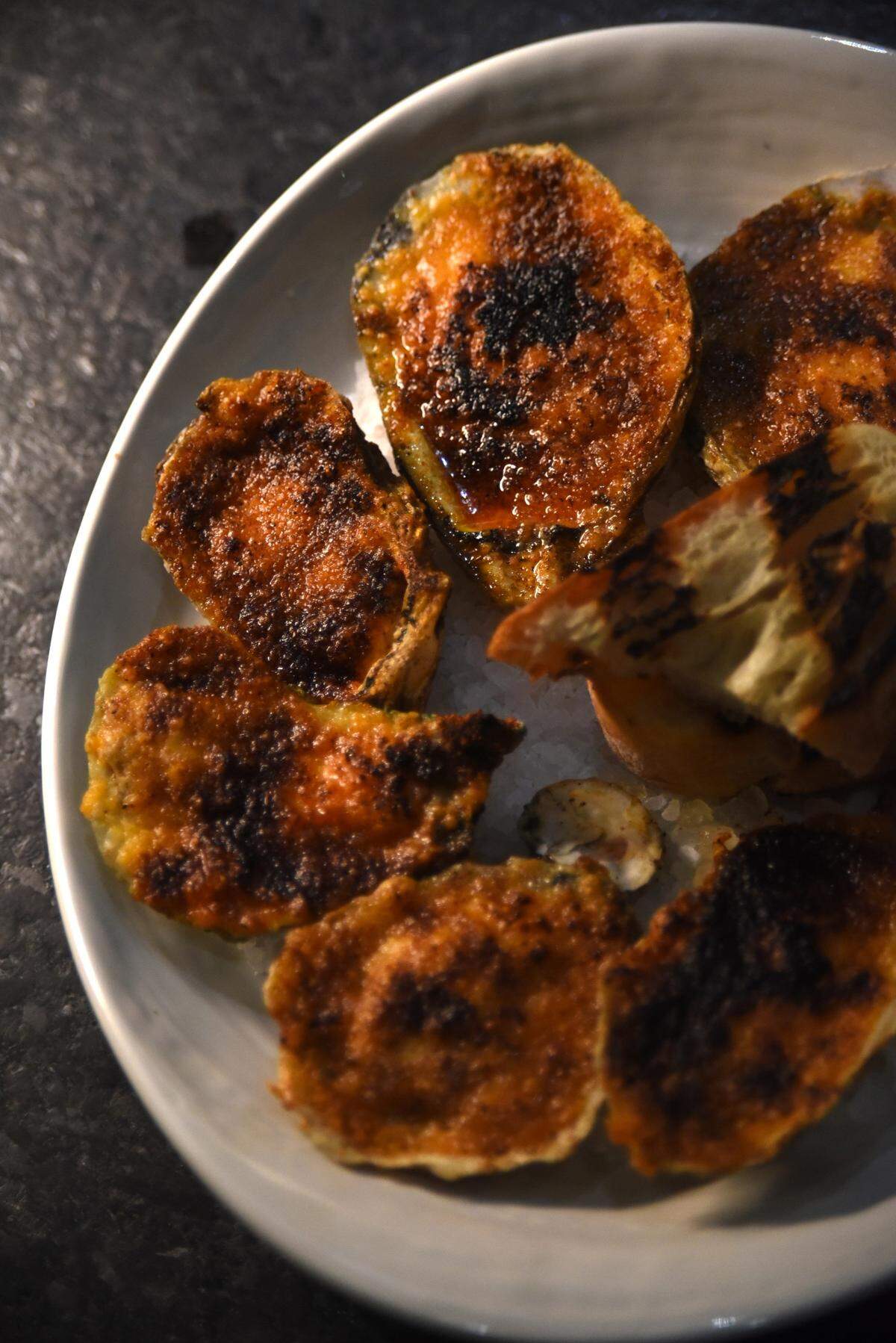 Charred oysters are among the small plate options at The Crunkleton in Raleigh.