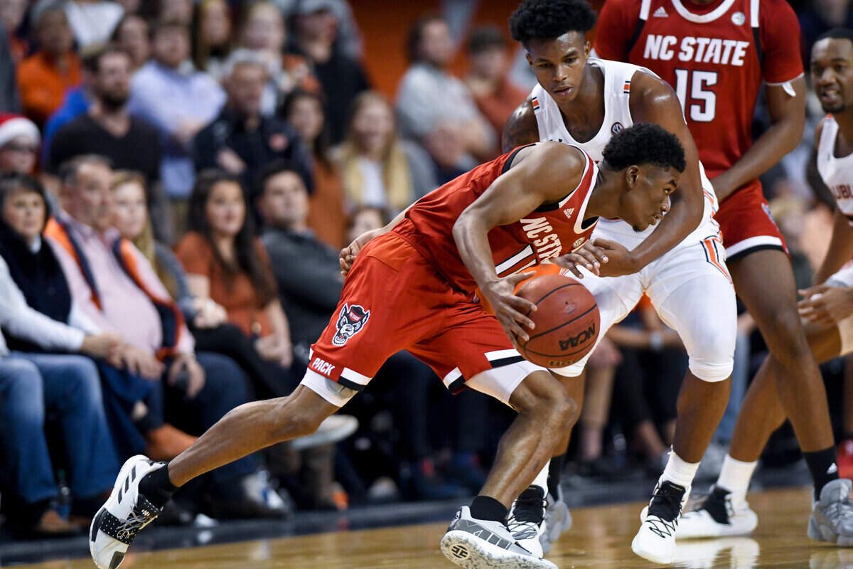 Auburn guard Allen Flanigan (22) defends North Carolina State guard Markell Johnson (11) during the second half of an NCAA college basketball game Thursday, Dec. 19, 2019, in Auburn, Ala.