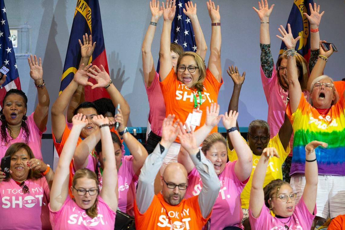 Healthcare workers do the wave as they wait for the arrival of President Joe Biden in the gymnasium at Green Road Community Center on Thursday, June 24, 2021 in Raleigh, N.C. Biden is making a stop in Wake County to promote COVID-19 vaccinations.