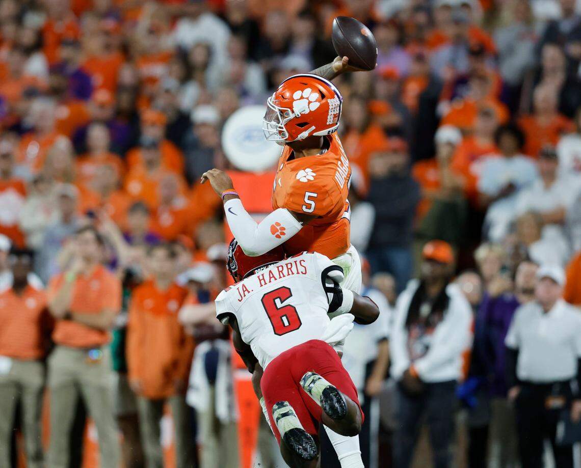 N.C. State safety Jakeen Harris (6) hits Clemson quarterback DJ Uiagalelei (5) as he throws during the first half of N.C. State’s game against Clemson at Memorial Stadium in Clemson, S.C., Saturday, Oct. 1, 2022.