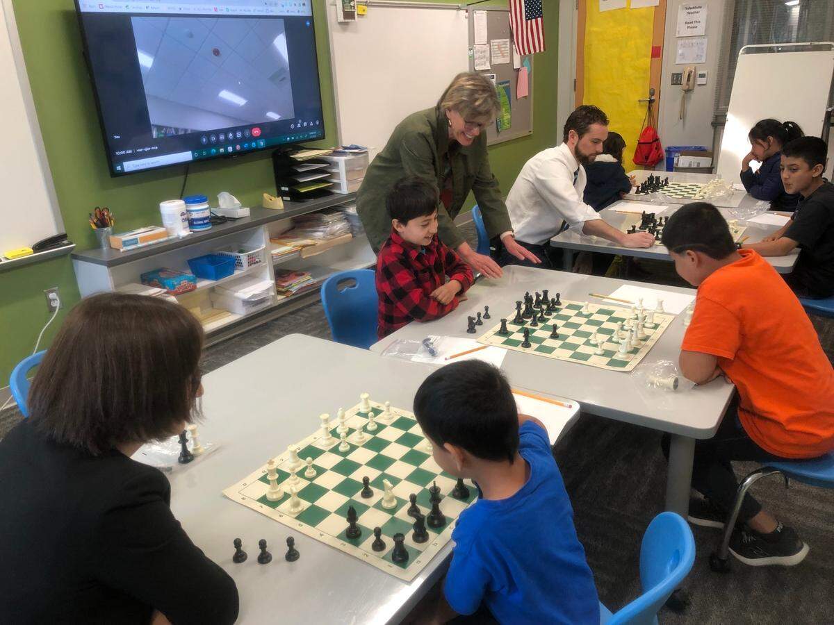 Afghan refugee students at Stough Elementary School learn how to play chess on April 1, 2022 in Raleigh, N.C.