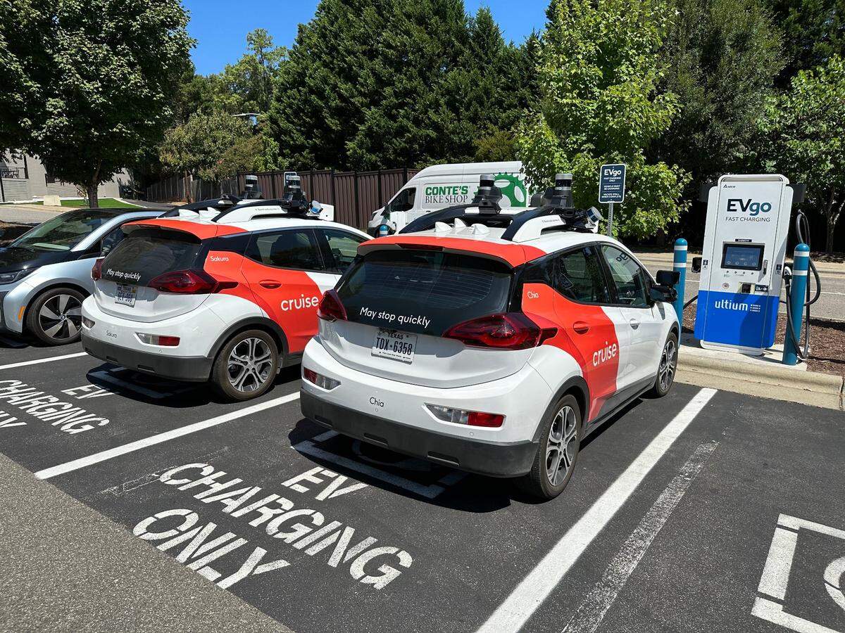 Two Cruise electric cars refuel at a charging station off Wade Avenue in Raleigh on Aug. 23, 2023. 