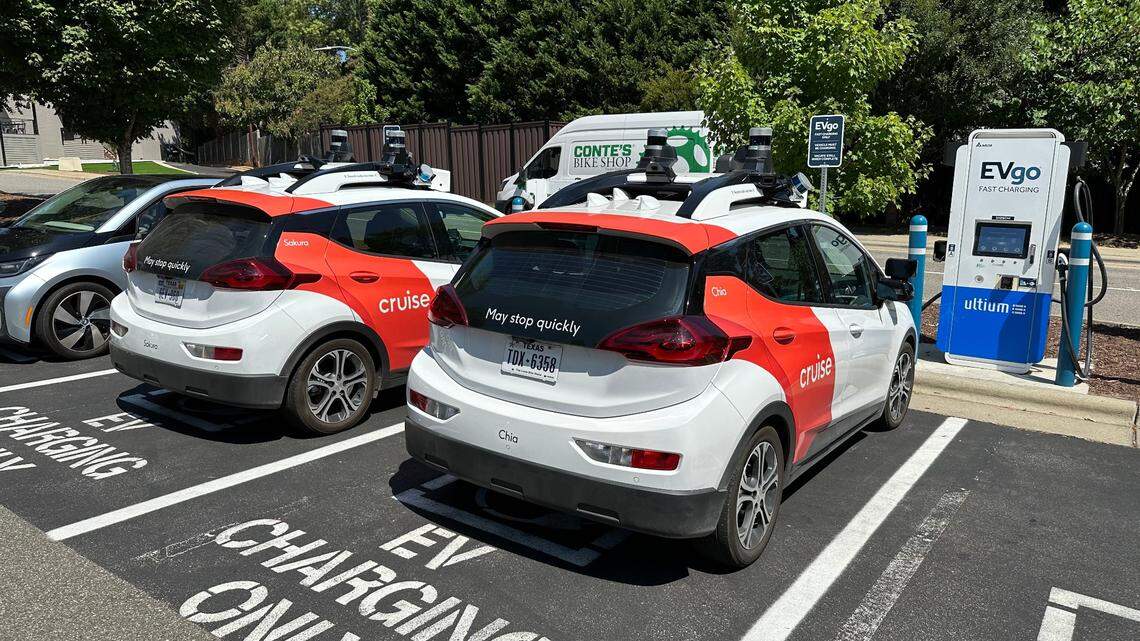Two Cruise electric cars refuel at a charging station off Wade Avenue in Raleigh on Wednesday, Aug. 23. Cruise is using its cars, with drivers, to gather data in the city in advance of introducing its driverless taxi service at some point in the future.