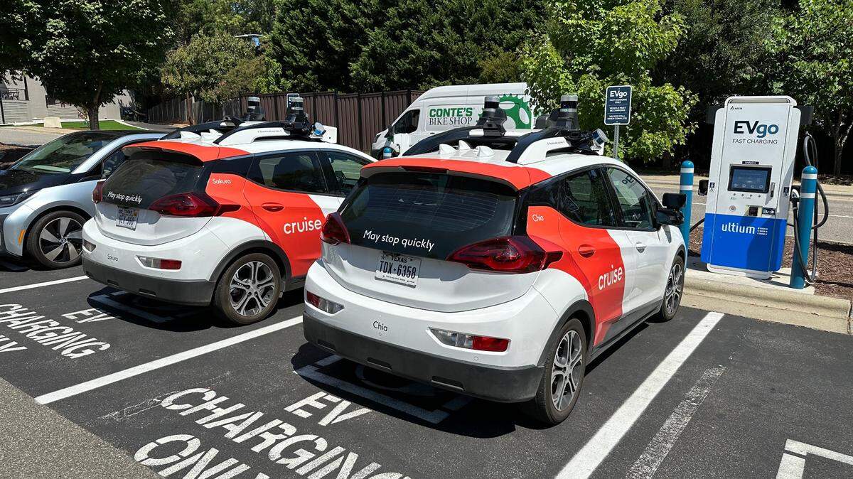 Two Cruise electric cars refuel at a charging station off Wade Avenue in Raleigh on Aug. 23.