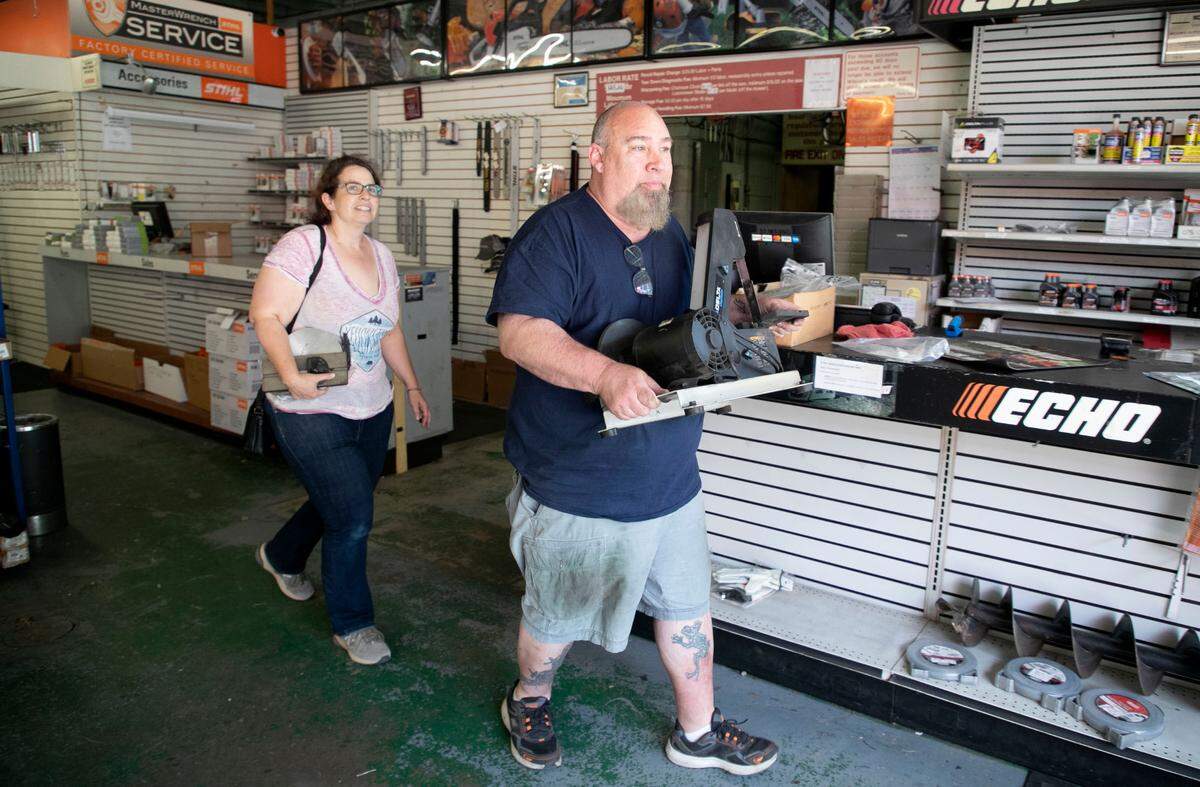 Jerry Boyd helps Heather Pinnix take her purchase out to her car at Wilson’s Outdoor Equipment in Raleigh, N.C., Tuesday, April 26, 2022. After more than five decades in business, Wilson’s Outdoor Equipment is closing up shop this spring, as the downtown Raleigh property it’s called home since 1968 gets demolished to make way for a high-rise apartment building.