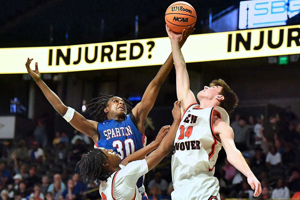 Sanderson’s Malakhi Murphy (30) competes with New Hanover’s Nolan Billings (14) for the rebound during the first half. The Sanderson Spartans and the New Hanover Wildcats met in the NCHSAA 4A East Regional Final in Winston-Salem, N.C. on March 12, 2025.