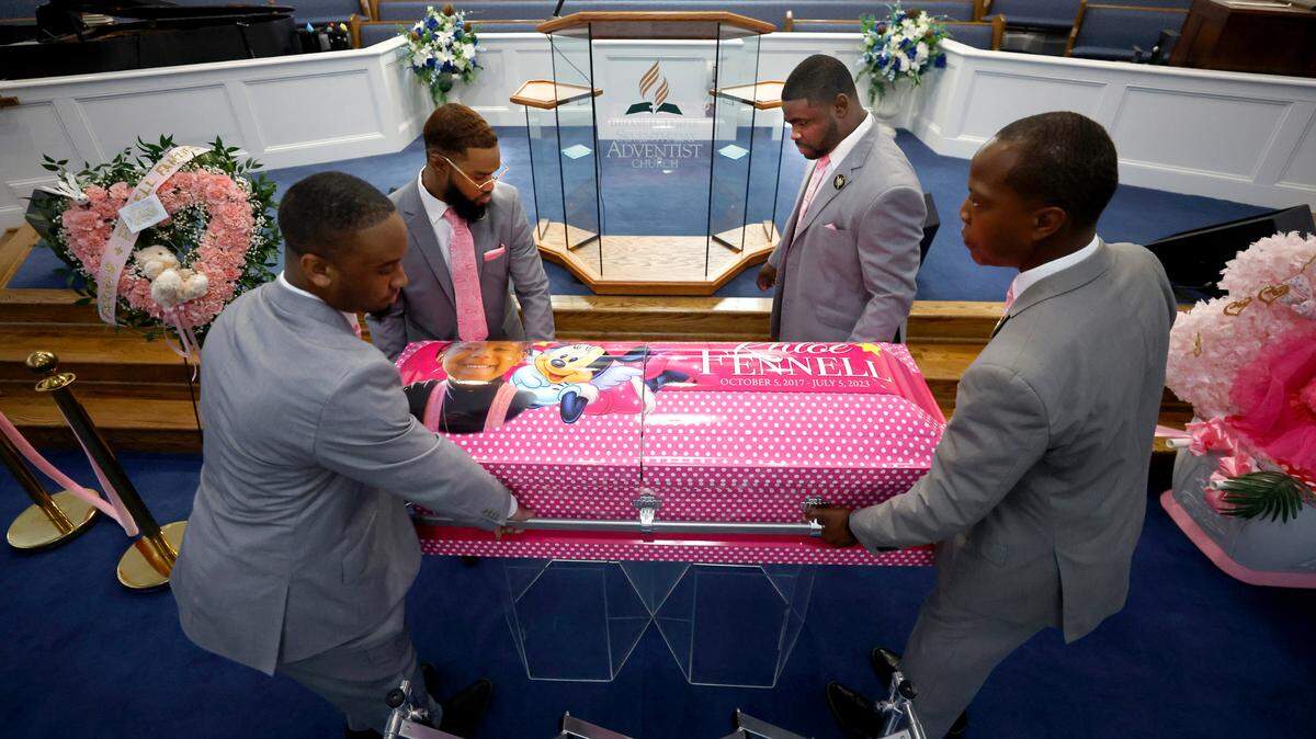 Clockwise from top left, Christopher Weaver, Curtis Peaks, Michael Kithcart and Kamal Simpson with Weaver & Peaks Funeral Care place the casket of five-year-old Khloe Fennell just below the pulpit at Immanuel Temple Church before her funeral in Durham, N.C., Friday, July 21, 2023. Fennell was killed by gunfire on July 5th.