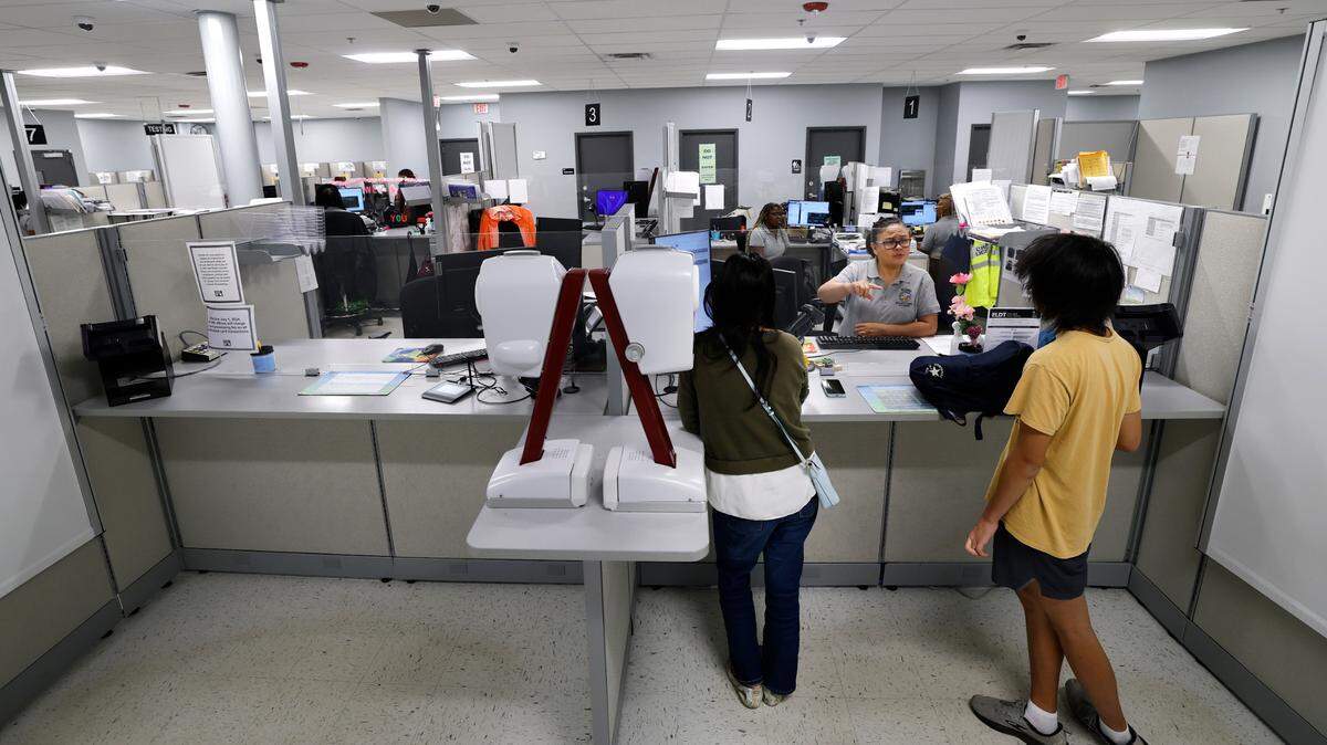 DMV examiner Glenda Brigino helps customers at the Raleigh East Driver License Office on May, 30, 2025. The office has 15 computer stations for driver’s license examiners but only seven examiners. 