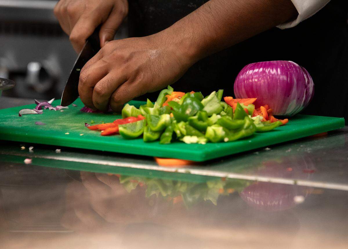 Debnath Ghosh chops vegetables in the kitchen of Tamasha Modern Indian on Wednesday, May 8, 2024, in Raleigh, N.C.