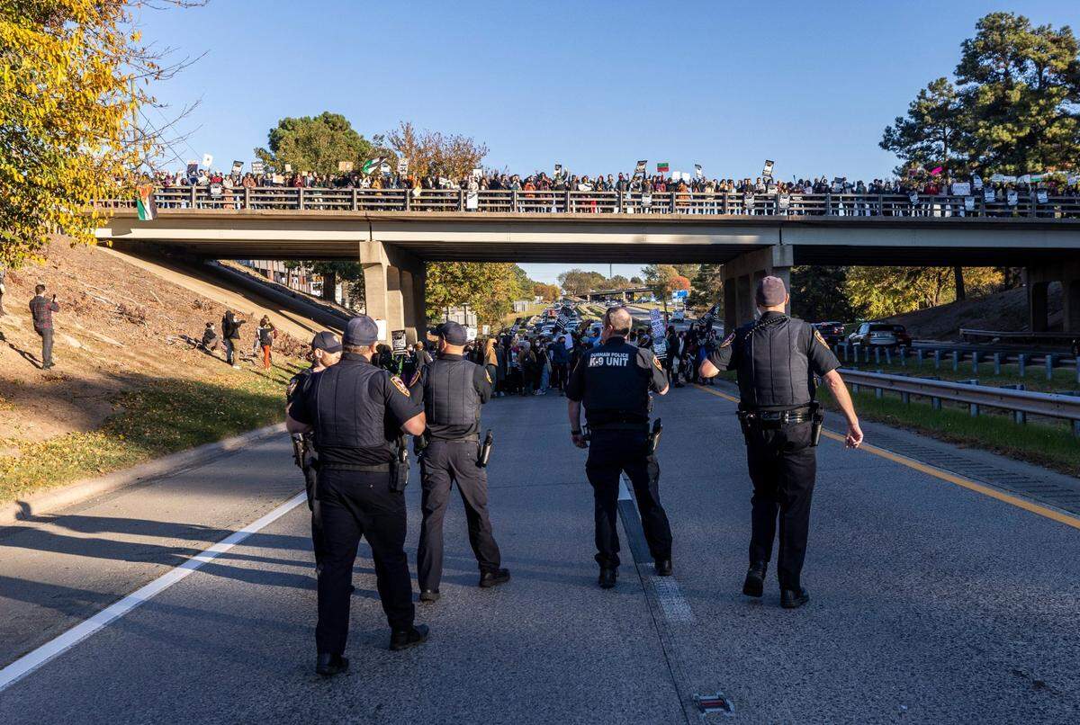 Protesters block the northbound lanes of the Durham Freeway at the South Magnum Street bridge for hours Thursday evening, Nov. 2, 2023 while demanding a ceasefire in the Israel-Gaza War as police warned of arrests.