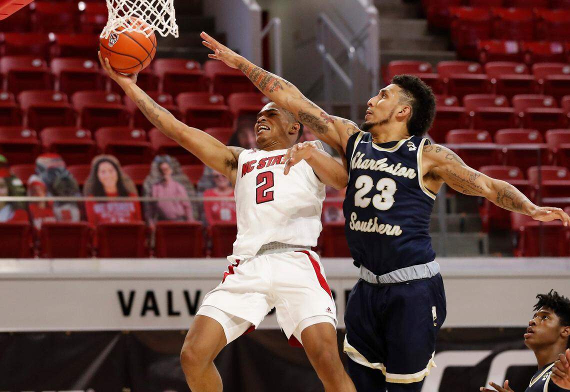 N.C. State’s Shakeel Moore (2) drives to the basket as Charleston Southern’s Sean Price (23) defends during the second half of N.C. State’s 95-61 victory over Charleston Southern in the Wolfpack Invitational at Reynolds Coliseum in Raleigh, N.C., Wednesday, Nov. 25, 2020.