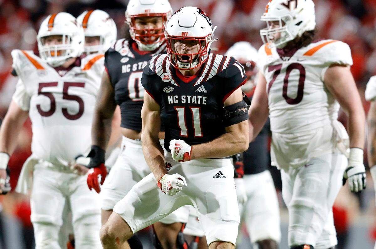 N.C. State linebacker Payton Wilson (11) celebrates after sacking Virginia Tech quarterback Grant Wells (6) during the first half of N.C. State’s game against Virginia Tech at Carter-Finley Stadium in Raleigh, N.C., Thursday, Oct. 27, 2022.