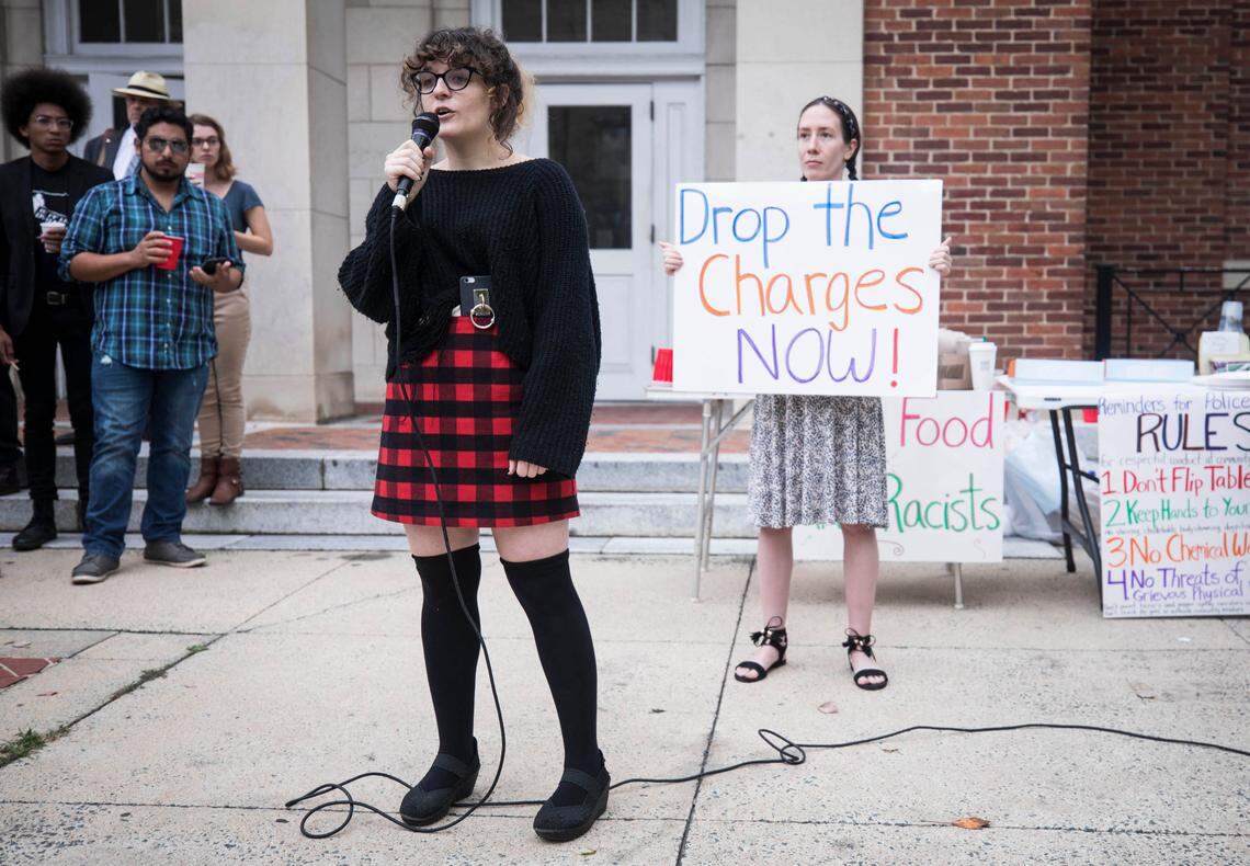 Gina Balamucki, left, a UNC-Chapel Hill law school student, speaks to a crowd of supporters gathered outside the Chapel Hill Courthouse before 11 defendants, facing charges related to Silent Sam demonstrations, appeared in court on Tuesday, Oct. 9, 2018. 