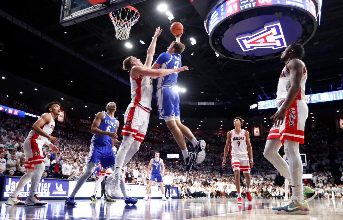 Duke’s Cooper Flagg (2) shoots as Arizona’s Motiejus Krivas (14) defends during Duke’s 69-55 victory over Arizona at the McKale Memorial Center in Tucson, Ariz., Friday, Nov. 22, 2024.