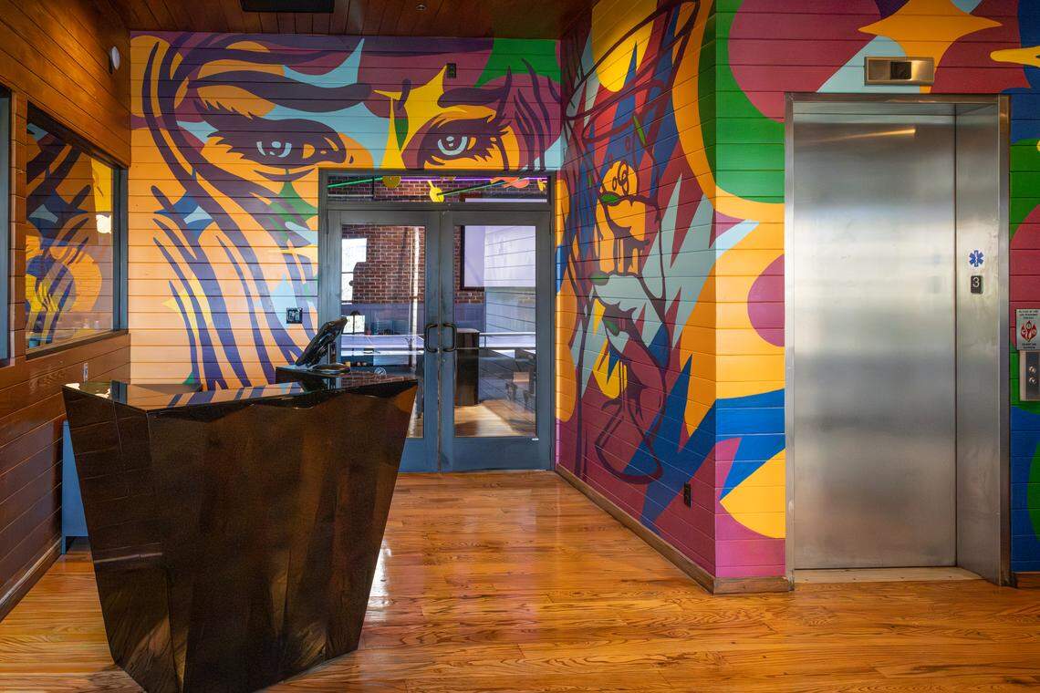 The main barroom and entrance at Smash Social Club features murals by Durham artist Gabriel Eng-Goetz.