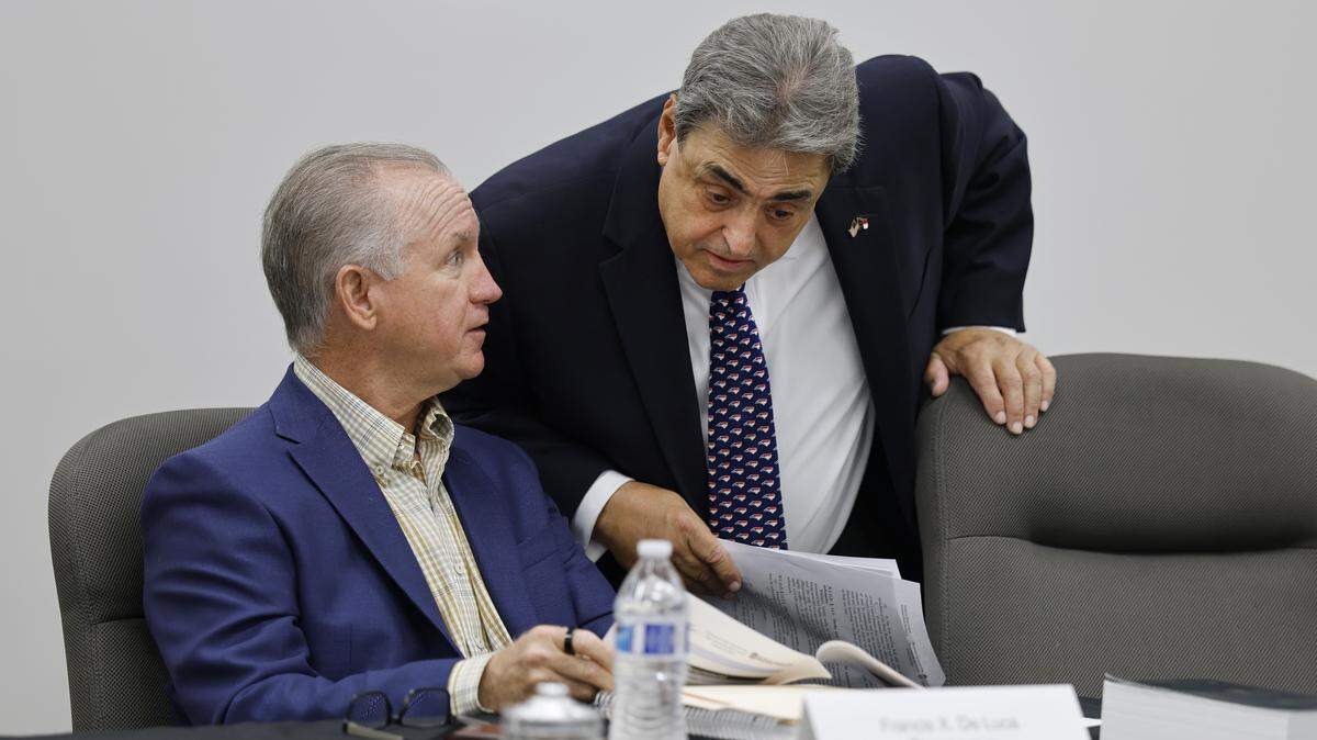 State Board of Elections member Bob Rucho, right, talks with chair Francis De Luca before their meeting on May 7, 2025. 