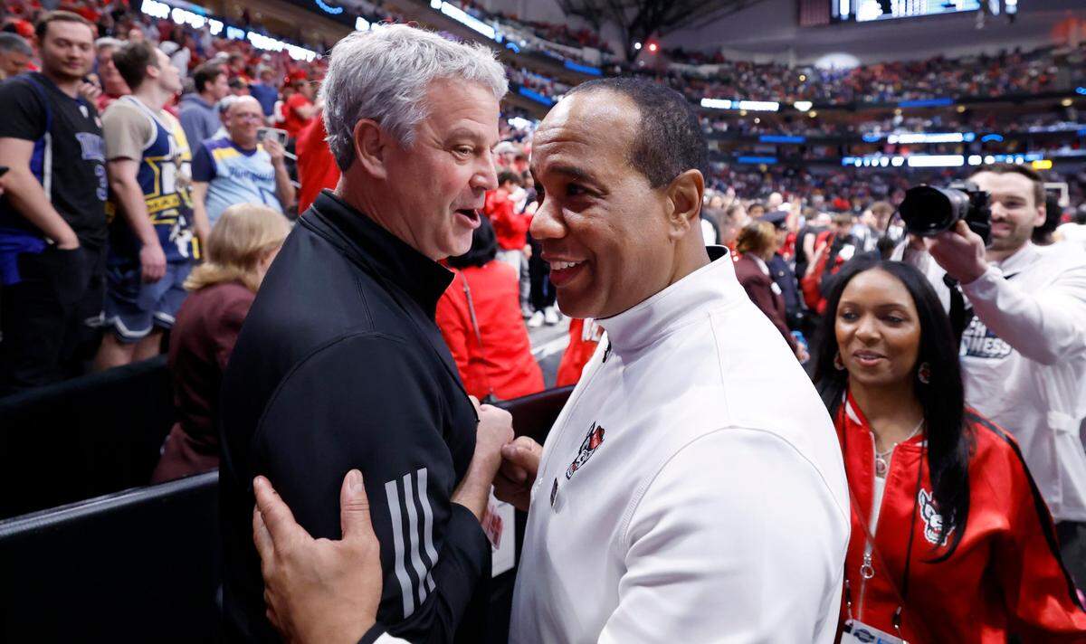 N.C. State athletics director Boo Corrigan celebrates with head coach Kevin Keatts after N.C. State’s 67-58 victory over Marquette in their NCAA Tournament Sweet 16 game at the American Airlines Center in Dallas, Texas, Friday, March 29, 2024.