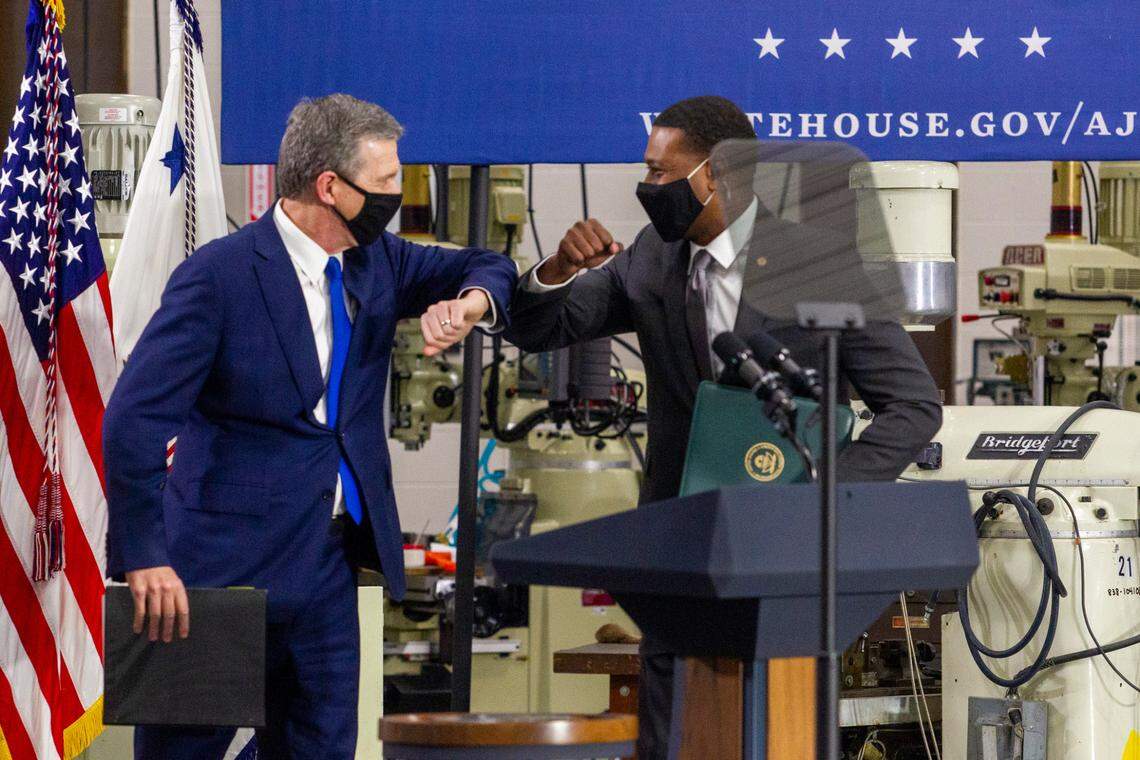 Gov. Roy Cooper elbow bumps Environmental Protection Agency Administrator Michael Regan during an event touting the Biden administration’s infrastructure plan Monday, April 19, 2021 at Guilford Technical Community College in Jamestown, NC.