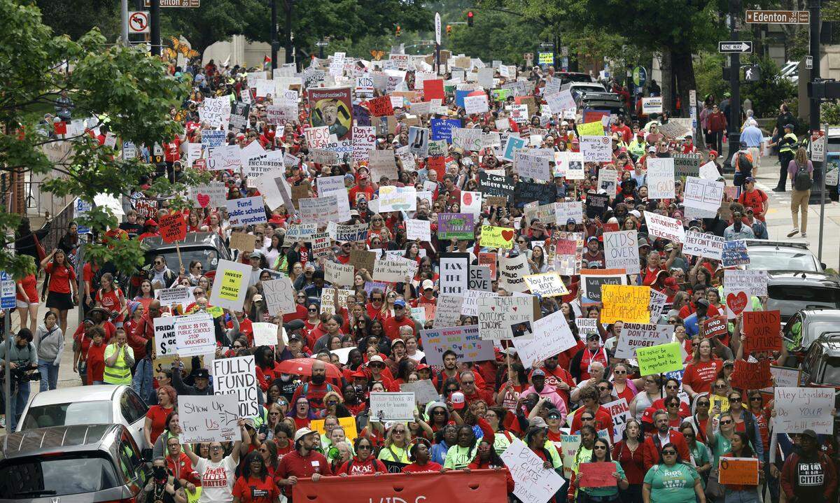 Thousands march down N. Salisbury St. in downtown Raleigh during a rally and march to protest for more school funding on Friday, May 1, 2026. The North Carolina Association of Educators mobilized teachers from across the state.