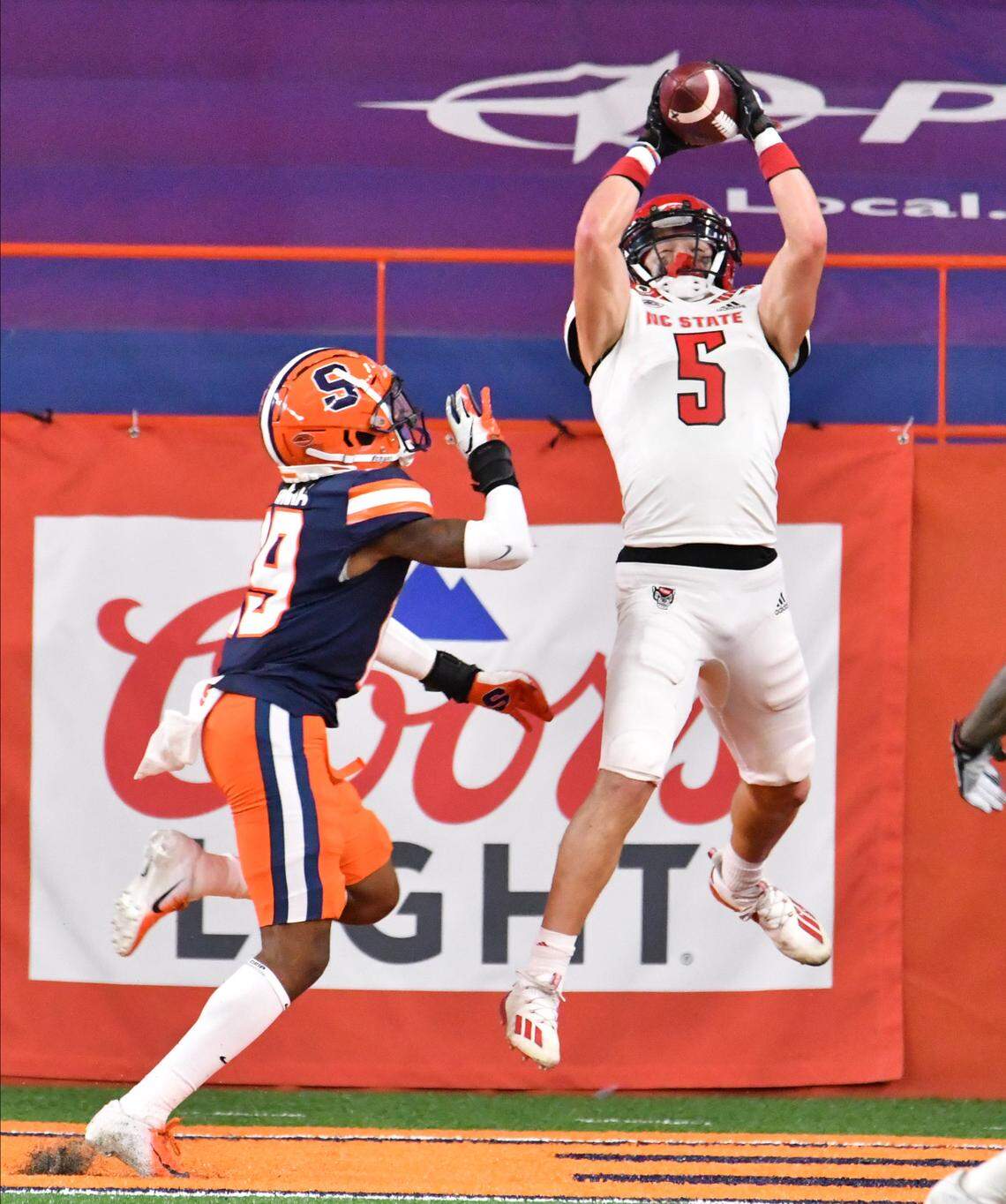 North Carolina State Wolfpack wide receiver Thayer Thomas (5) catches a touchdown pass in front of Syracuse Orange defensive back John Sweetwood (29) in the second quarter at the Carrier Dome.