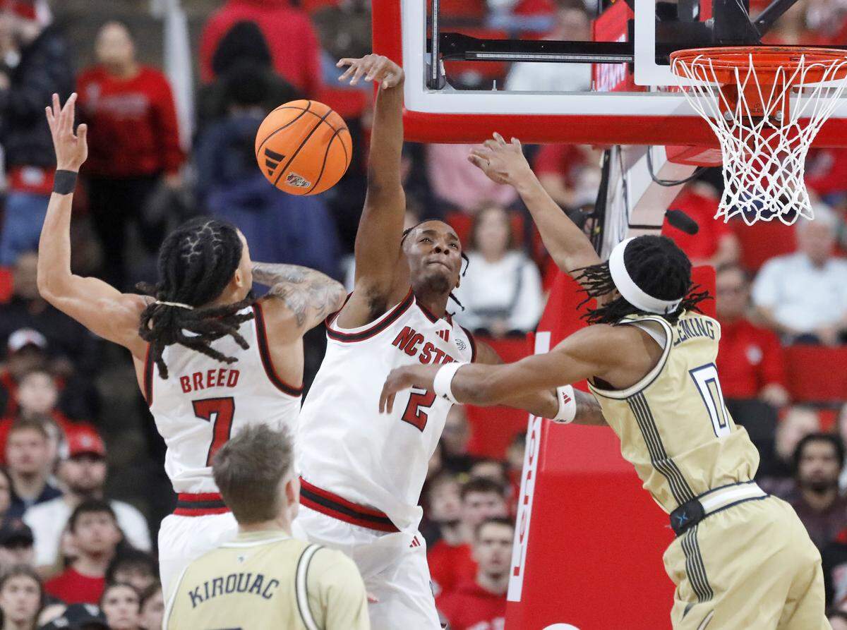 N.C. State’s Paul McNeil Jr. blocks a shot by Georgia Tech’s Akai Fleming during the first half of the Wolfpack’s game on Saturday, Jan. 17, 2026, at Lenovo Center in Raleigh, N.C.