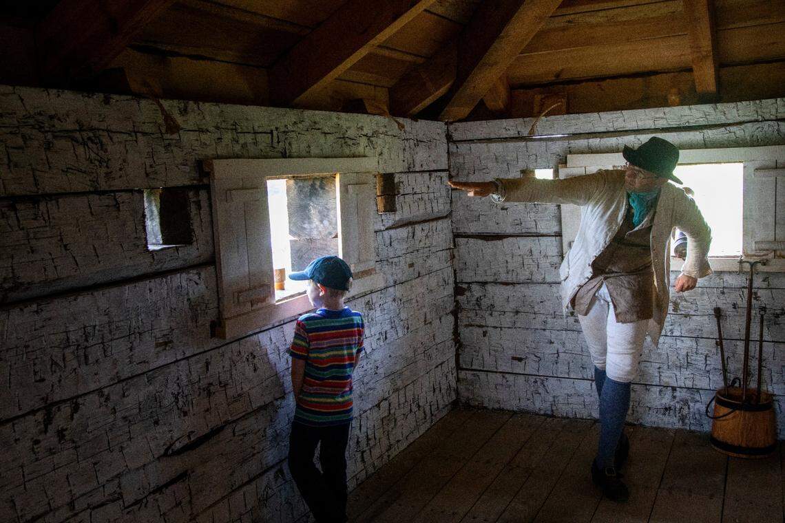 Alex Shore, 7, of Raleigh gets a tour of the Fort Dobbs Historic Site fromsite manager Scott Douglas. The fort is a recreation of a fort built in 1755 when North Carolina was still a colony.