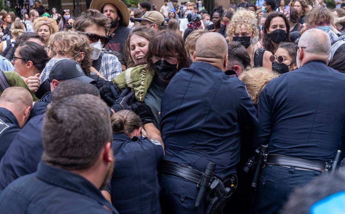 Pro-Palestinian demonstrators clash with police after replacing an American flag with a Palestinian flag Tuesday, April 30, 2024 at UNC-Chapel Hill. Police removed a “Gaza solidarity encampment” earlier Tuesday morning.