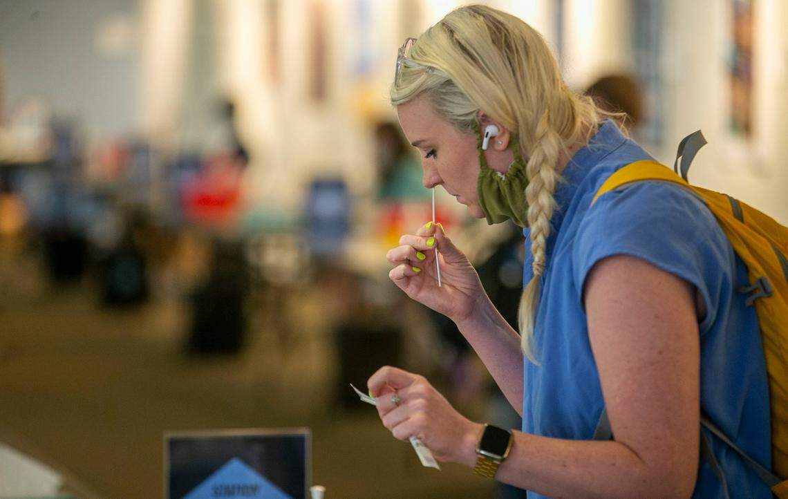 Nikki Phillips takes a nasal swap for a COVID-19 test in the Student Union at the University of North Carolina on the first day of classes on Wednesday, August 18, 2021 in Chapel Hill, N.C. Thousands of students have returned to campus amid a surge in COVID-19 cases.