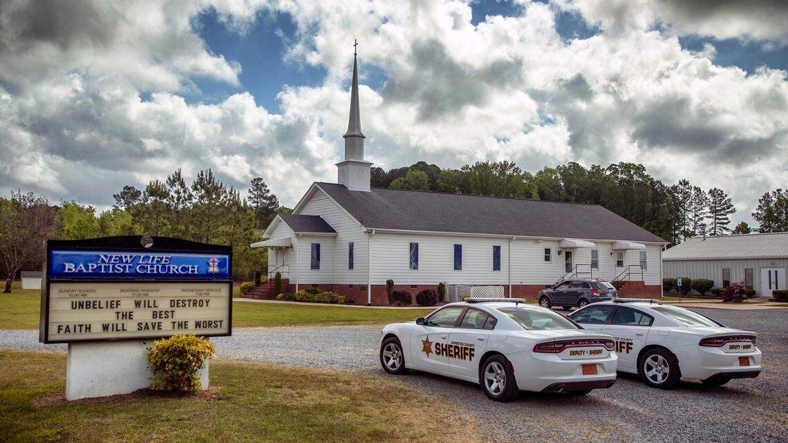Johnston County Sheriff’s Office patrol cars park near the entrance of New Life Baptist Church, with two deputies inside during their 11am worship, hired by Rev. Steve Grice to protect the congregation from threats received online for announcing they would be defying Gov. Roy Cooper’s executive order to limit gatherings to 10 people in an effort to slow the spread of COVID-19, on Sunday, May 17, 2020, in Smithfield, N.C.