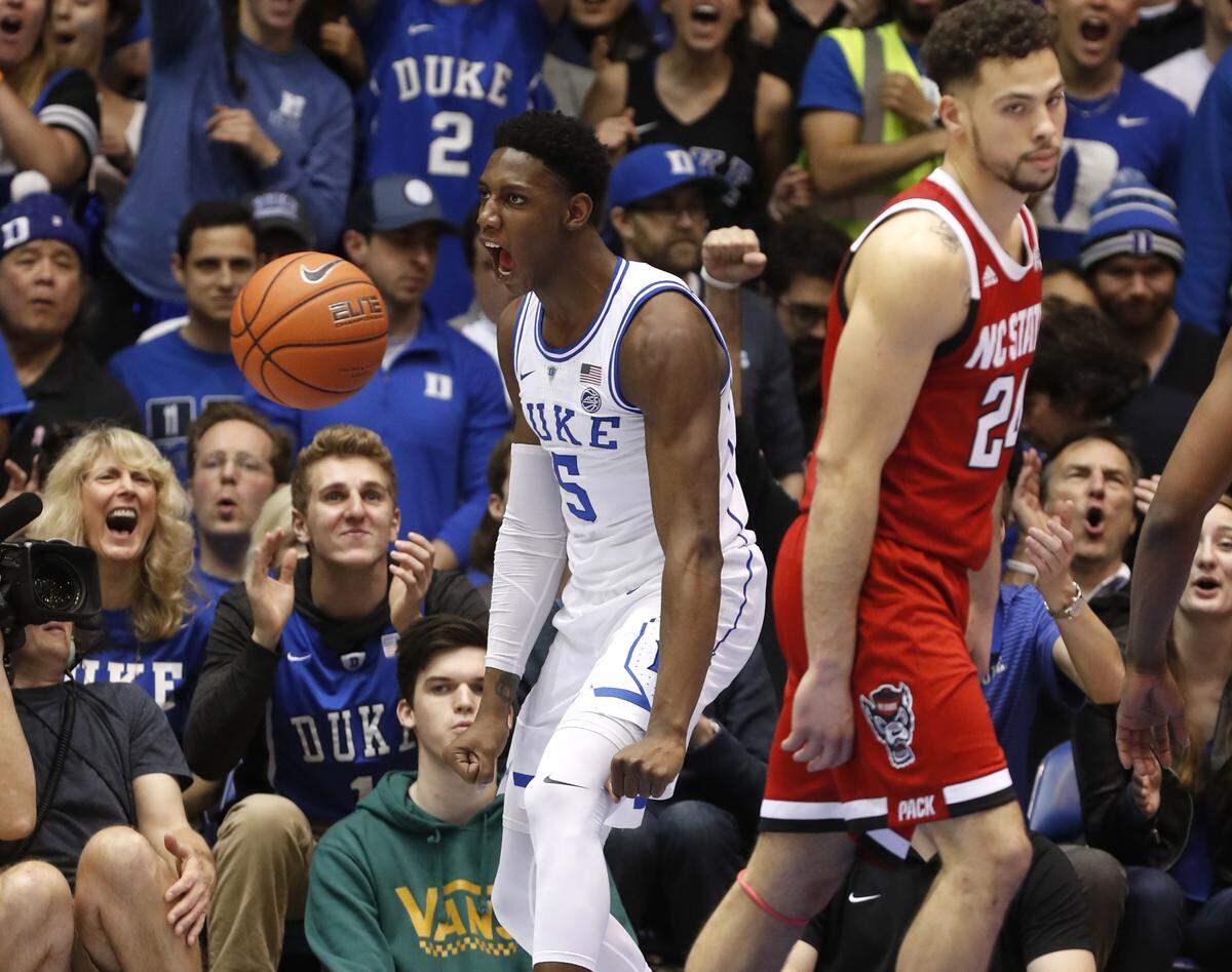 Duke’s RJ Barrett (5) celebrates after slamming in two during the second half of Duke’s 94-78 victory over N.C. State at Cameron Indoor Stadium in Durham, N.C., Saturday, Feb. 16, 2019. N.C. State’s Devon Daniels (24) is to the right.