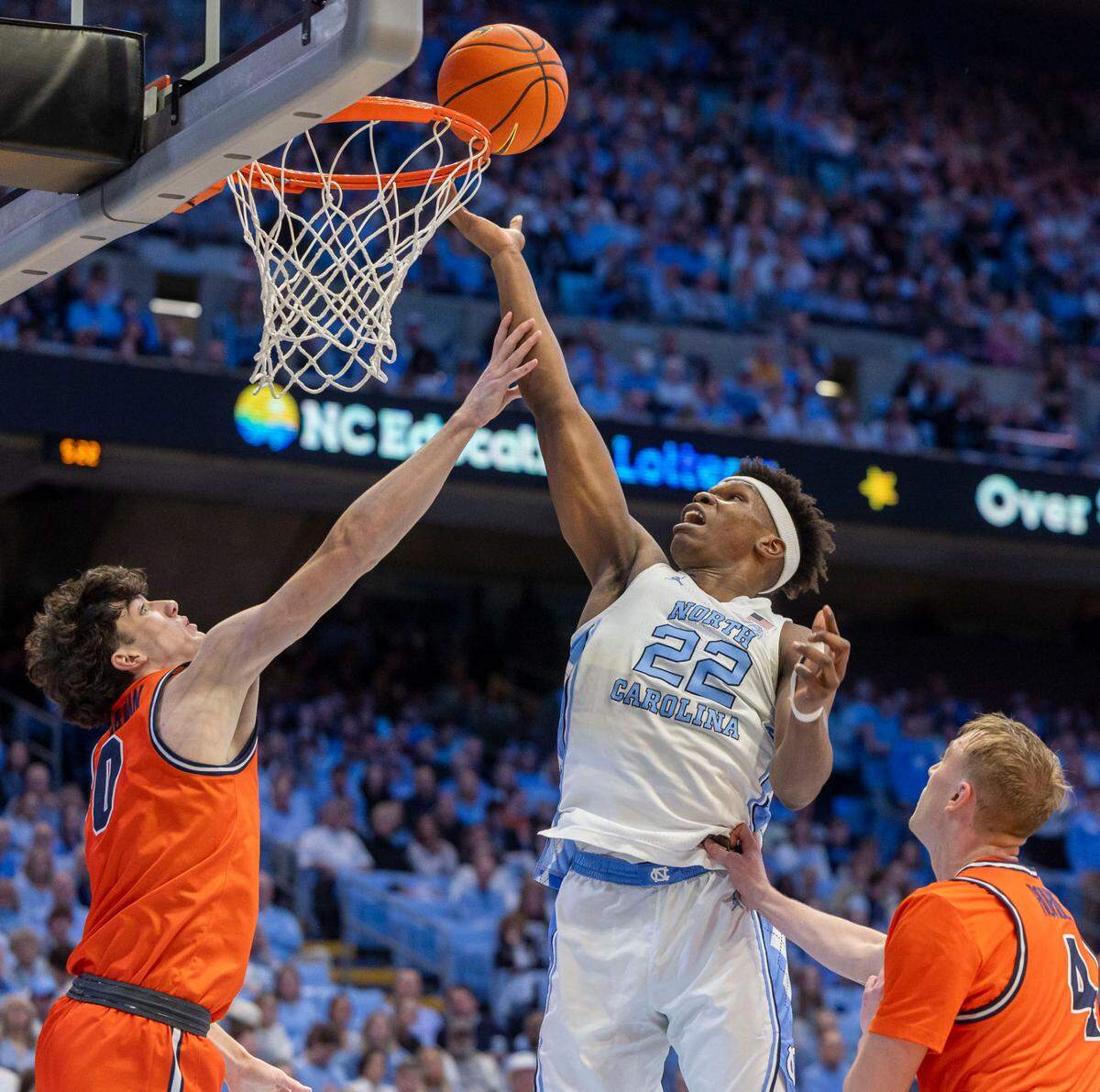 North Carolina’s Ven-Allen Lubin (22) works to tip in a missed basket against Virginia’s Blake Buchanan (0) in the second half on Saturday, February 22, 2025 at the Smith Center in 6 victory Chapel Hill, N.C. Lubin scored 14 points in the Tar Heels’ victory.