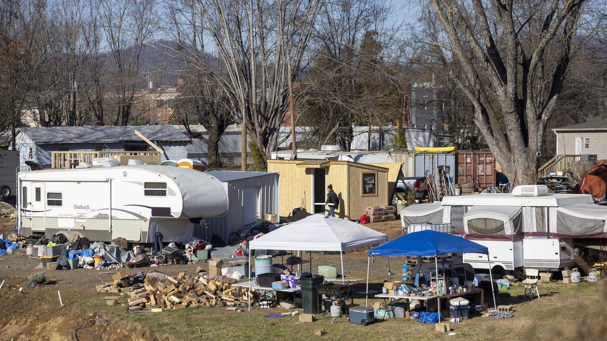 Makeshift housing along the Swannanoa River, in Swannanoa, North Carolina, on Dec. 20, 2024, three months after flooding from Hurricane Helene. Some residents were living in travel trailers while temporary housing units was built.
