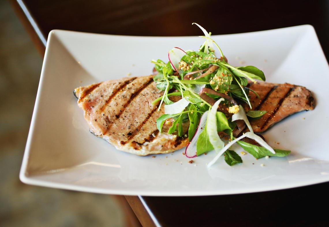 The wood-grilled sunburst trout is a generous fillet, grilled to a sweetly succulent turn, is half submerged beneath a tangle of shaved fennel, radish, red onion, arugula and cornbread crumbles in a charred citrus and burnt honey vinaigrette.