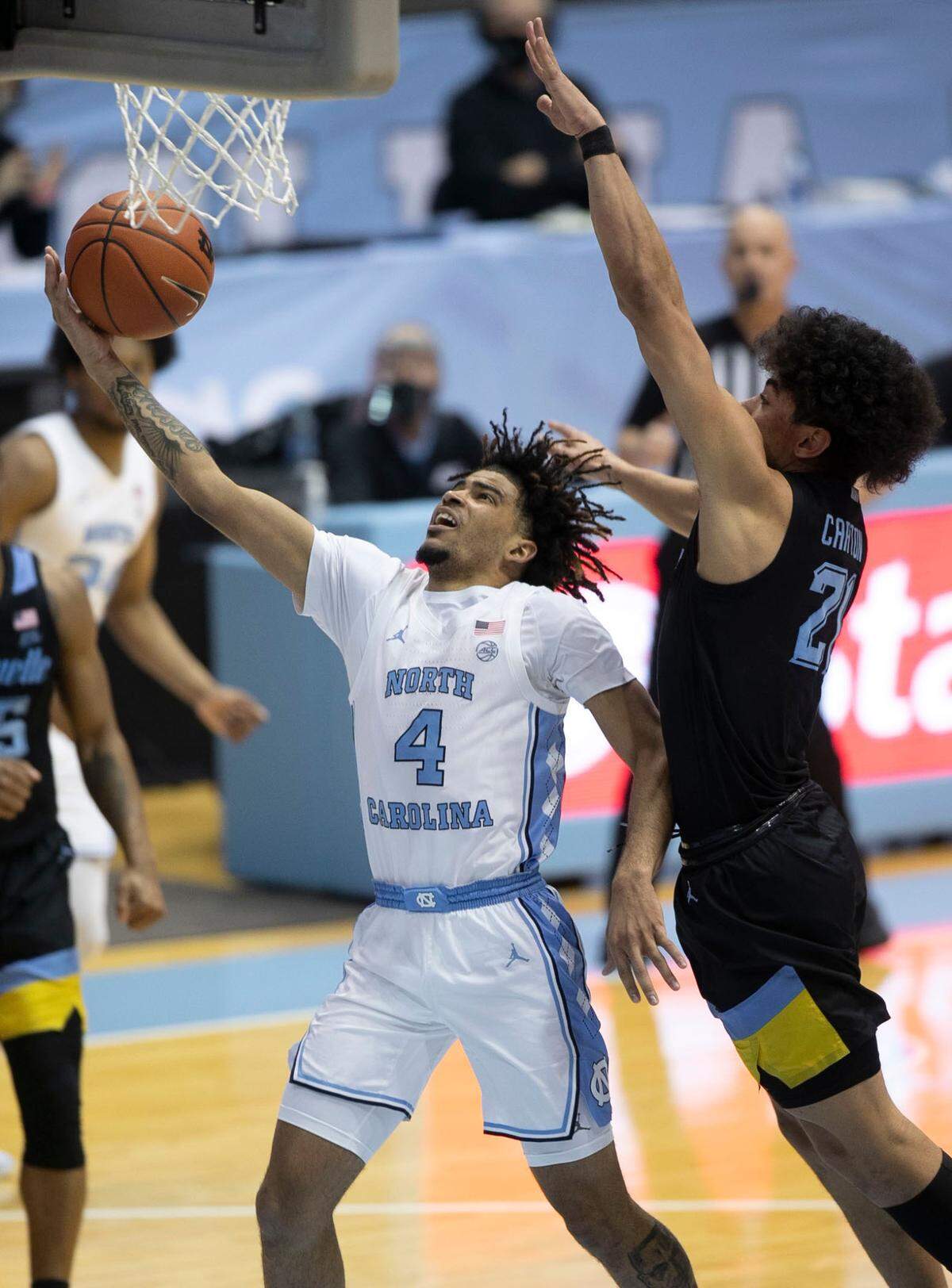 North Carolina’s R.J. Davis (4) breaks to the basket in the second half against Marquette’s D.J. Carton (21) on Wednesday, February 24, 2021 at the Smith Center in Chapel Hill, N.C.