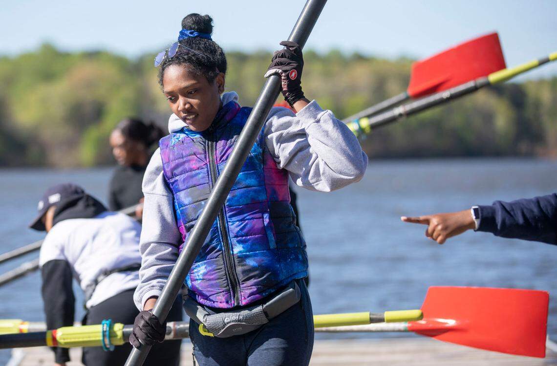 Jordyn Burton, a senior at Saint Augustine’s University, prepares to get in a rowing shell at Lake Wheeler in Raleigh, N.C. for crew practice on Sunday, April 10, 2022.