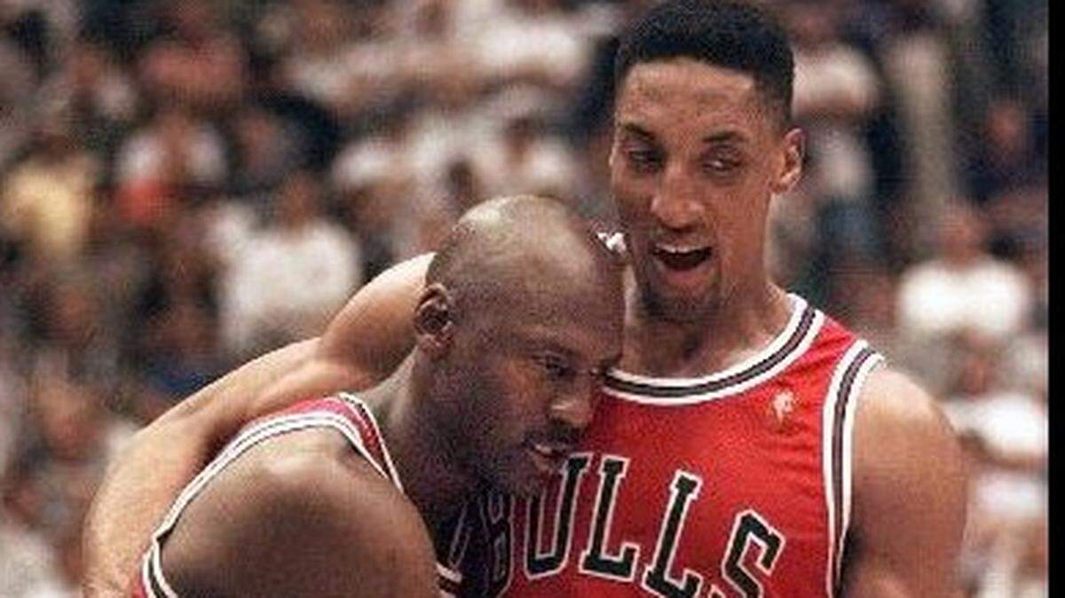 Chicago Bulls’ Michael Jordan is helped off the court by teammate Scottie Pippen, right, at the end of Game 5 of the NBA Finals. Jordan was fighting flu-like symptoms, and scored 38 points as the Bulls beat the Jazz 90-88 on June 11, 1997.