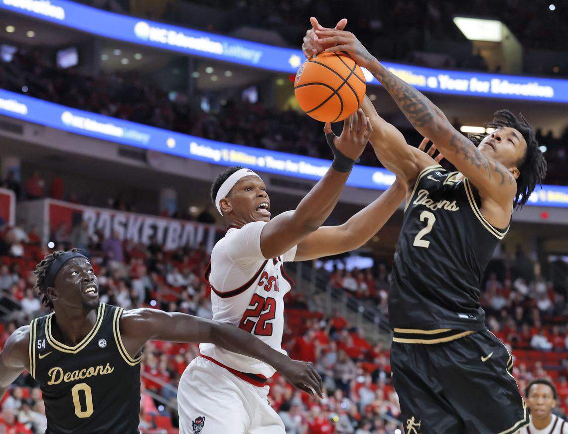 N.C. State’s Ven-Allen Lubin battles for a rebound with Wake Forest’s Omaha Biliew and Juke Harris during the second half of the Wolfpack’s 70-57 win on Wednesday, Dec. 31, 2025, at Lenovo Center in Raleigh, N.C.