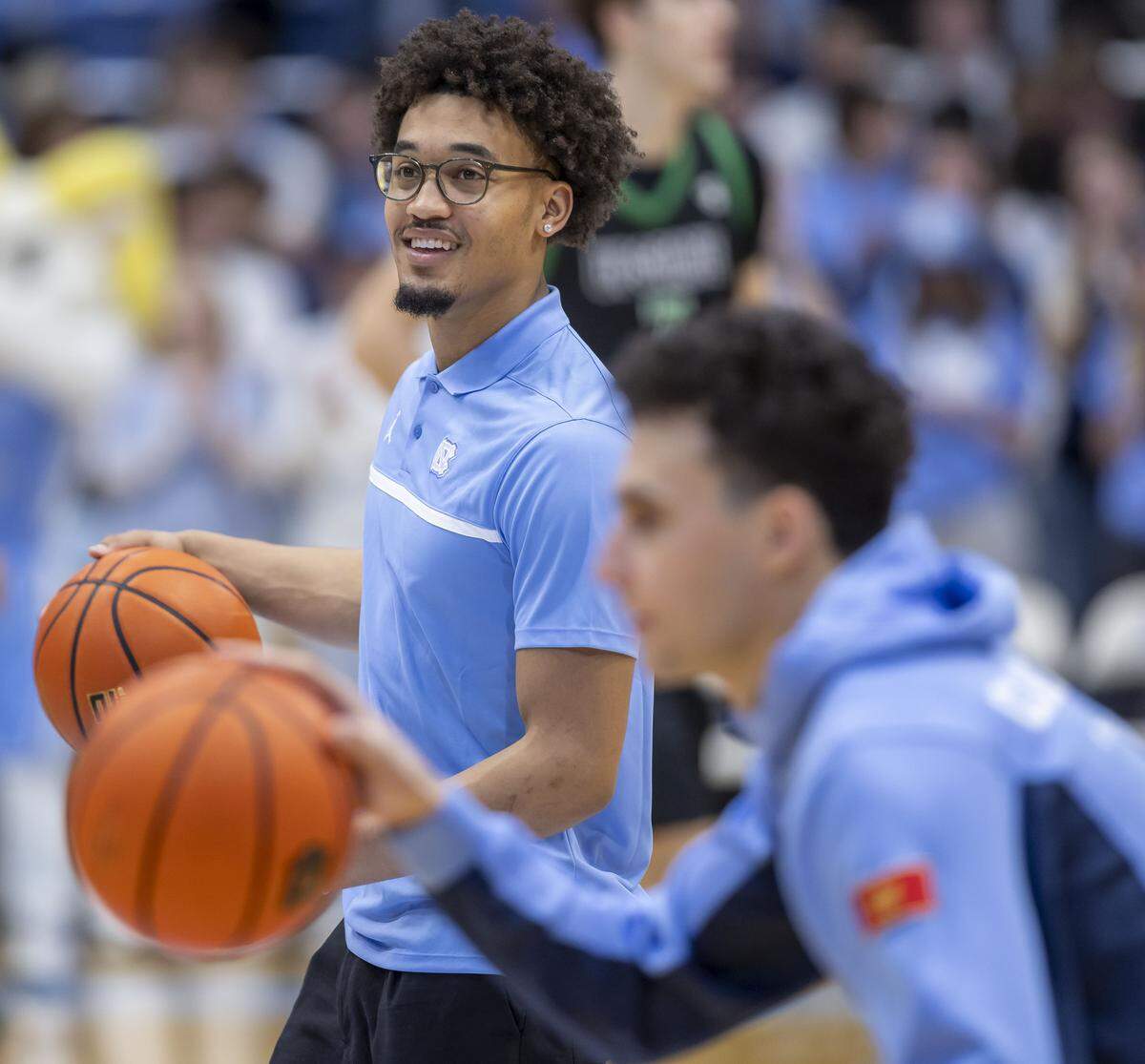 North Carolina guard Seth Trimble (7) dribbles the ball as he watches his teammates warm up for their game against USC Upstate on Saturday, December 13, 2025 at the Smith Center in Chapel Hill, N.C. Trimble is expected to resume full contact practice soon as he continues to recover from surgery on his left arm. 