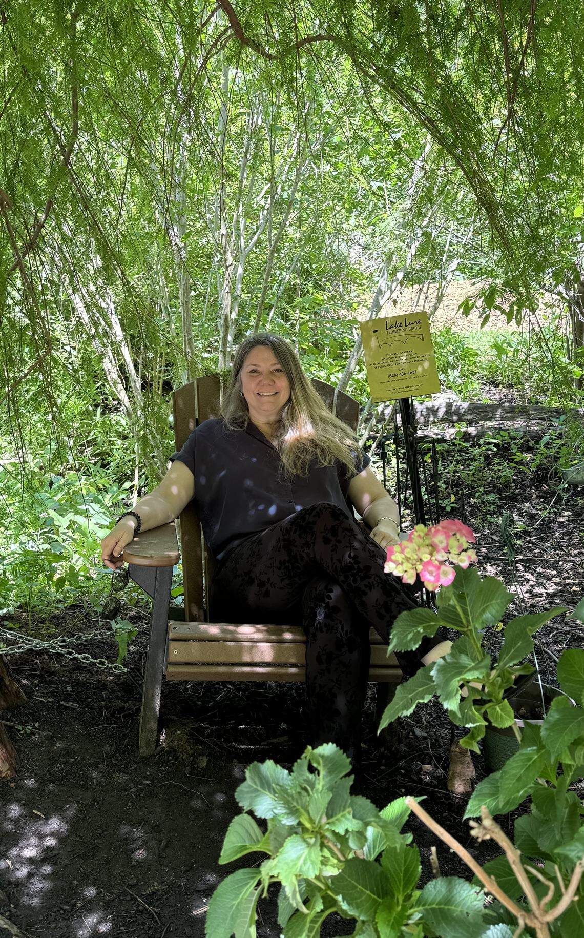 Kris Willing, a regular visitor to Lake Lure Flowering Bridge, relaxes in its shade.