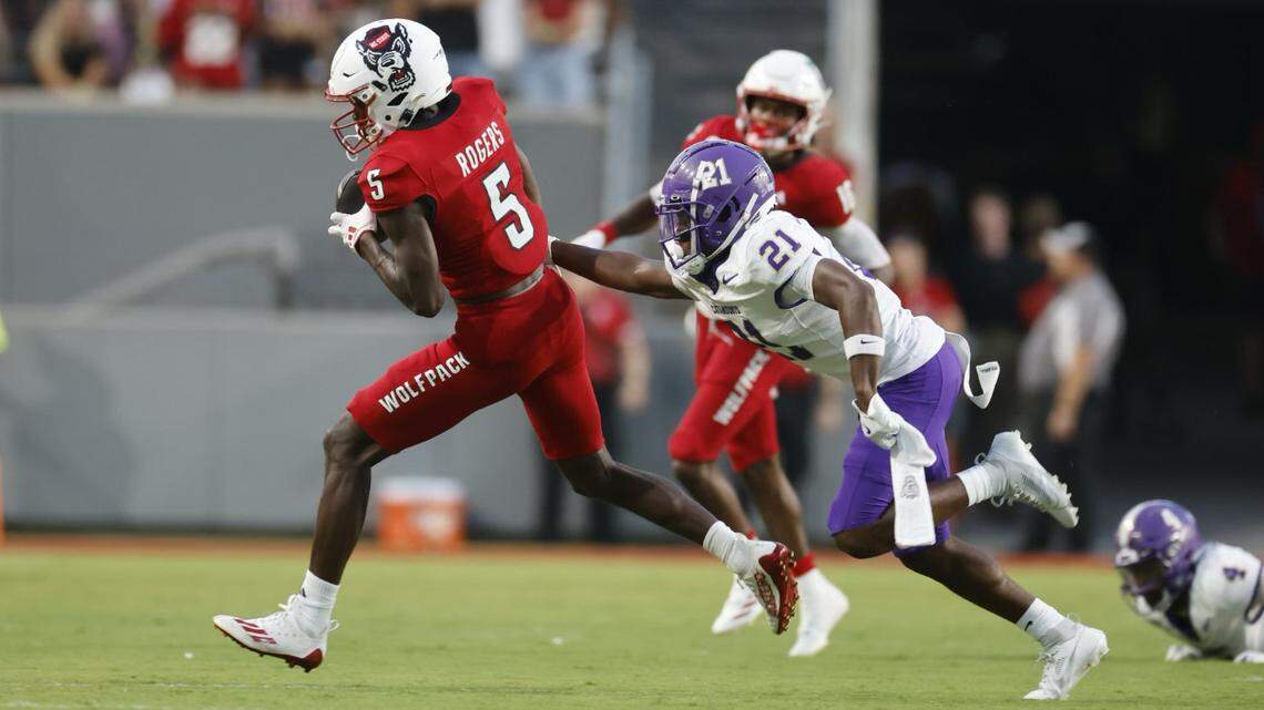 NC State wide receiver Noah Rogers (5) runs for a gain as Western Carolina’s Bo Simpson-Nealy (21) defends in first quarter action in the season opener at Carter-Finley Stadium, Thursday, August 29, 2024.
