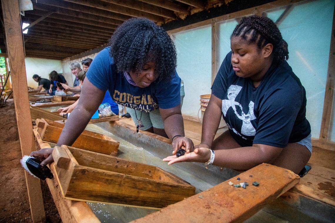 Whittany Bennett shows off one of her finds from the Emerald Hollow Mine in Hiddenite. The mine is billed as “the only Emerald Mine in the world open to the public for prospecting.”