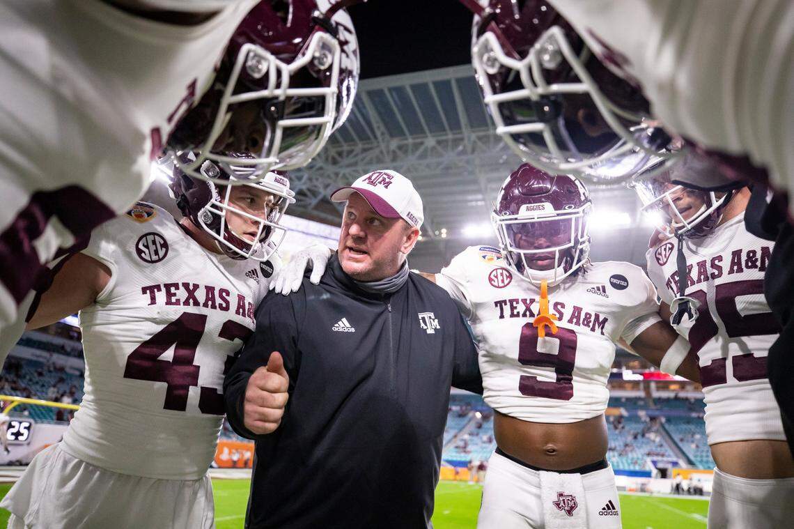 Texas A&M defensive coordinator Mike Elko talks to his players before the Capital One Orange Bowl game against North Carolina at Hard Rock Stadium in Coral Gables, FL. Jan. 2, 2021.