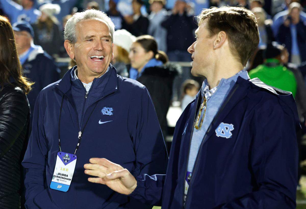 North Carolina athletics director Bubba Cunningham laughs with Chancellor Lee Roberts after UNC’s 1-0 victory over Wake Forest in the finals of the 2024 Women’s College Cup at WakeMed Soccer Park in Cary, N.C., Monday, Dec. 9, 2024.