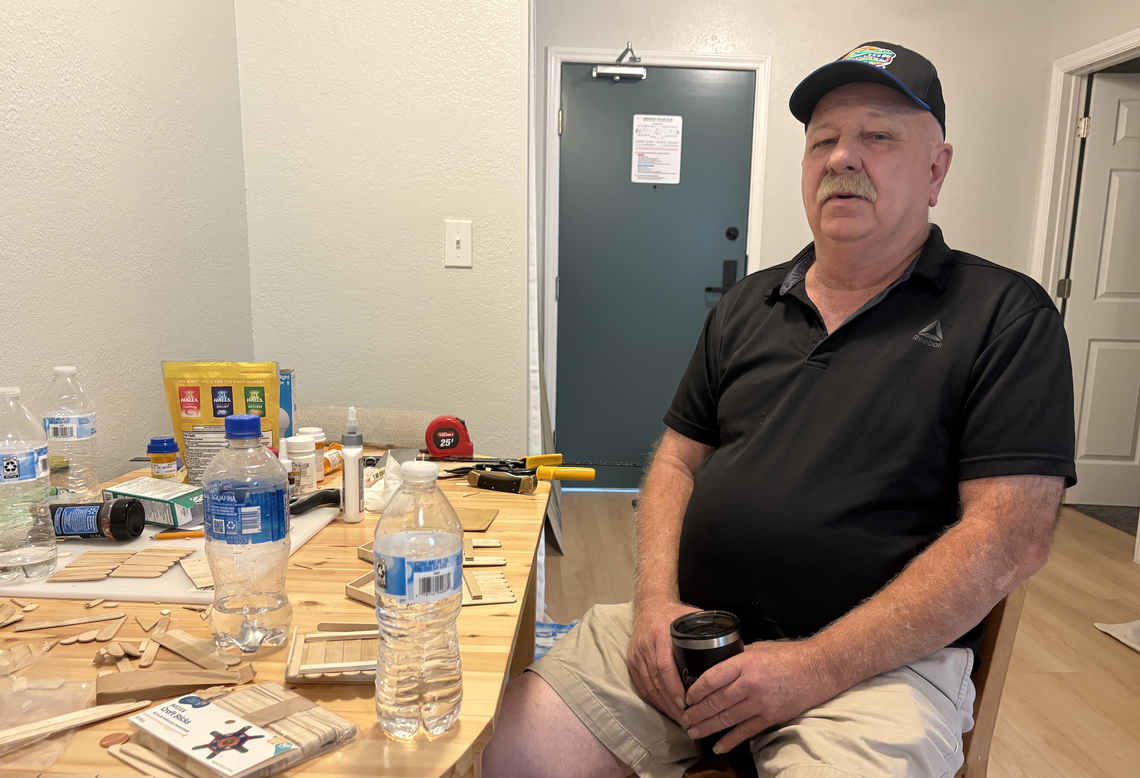 Teddy Pugh sits inside his new studio apartment at The Pines in Morrisville.