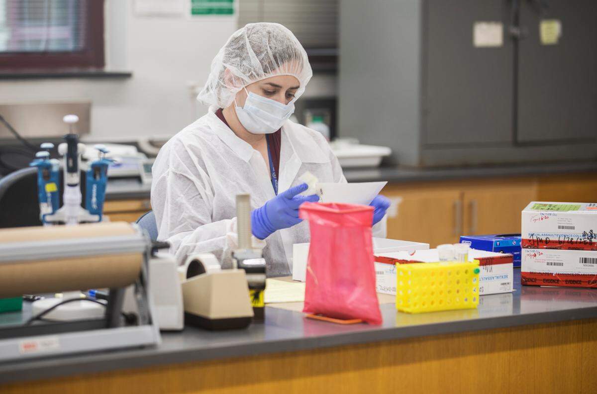Forensic biologist Jessica McLamb takes inventory of a Sexual Assault Evidence Collection Kit at the State Crime Lab in Raleigh, N.C. on Sept. 30, 2021.